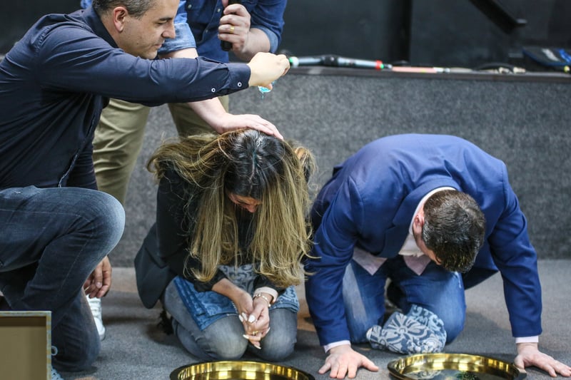 A new pastor and his wife are dedicated by being anointed with oil. Photo: Phil Taylor