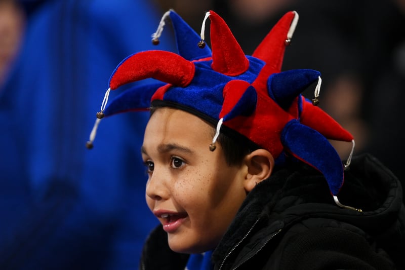 A fan of Crystal Palace wearing a jester hat looks on prior to the Premier League match 