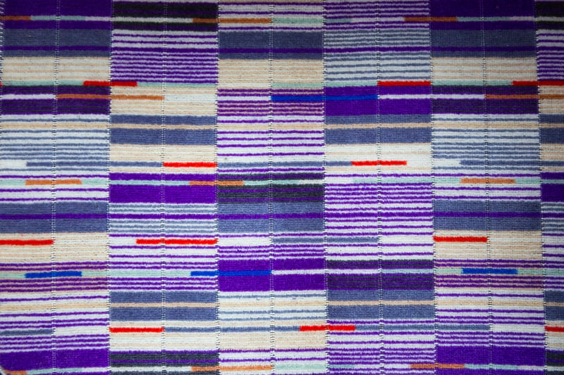 The new bespoke Elizabeth line moquette is a mix of purples, blues, greys, and beige, with small flashes of orange and red- a colour scheme reflecting the line’s royal associations and echoing the purple of the new line signage. Credit: TfL 