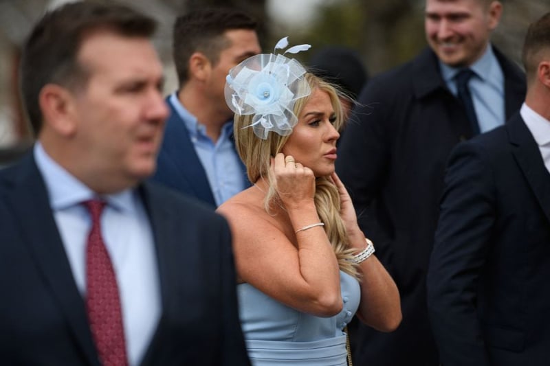 Racegoers attend the opening day of the Grand National Festival.