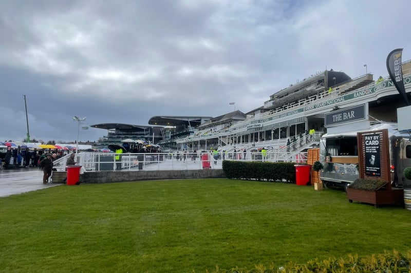 Dark clouds gather over Aintree as wet and windy weather hits the opening day.