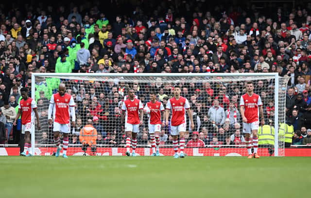 Arsenal players react after conceding a second goal  during the English Premier League (Photo by JUSTIN TALLIS/AFP via Getty Images)