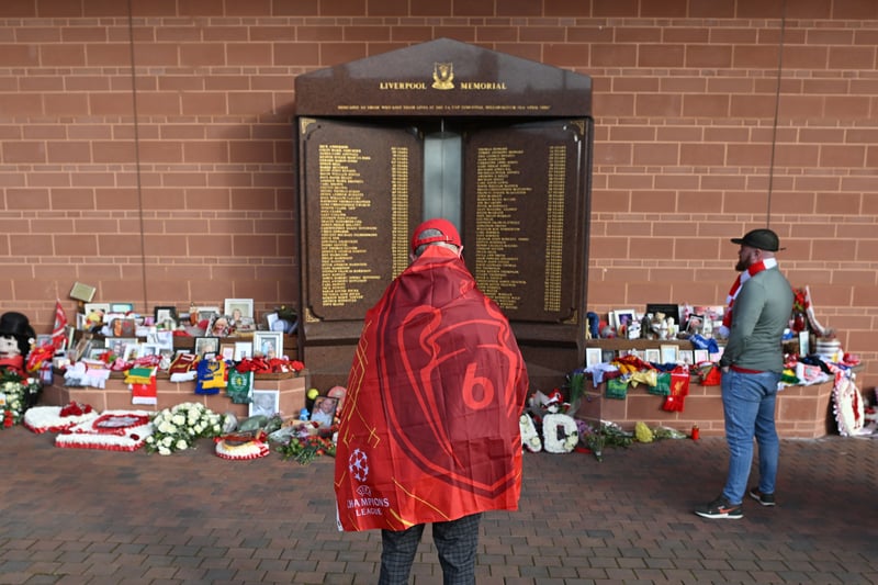 Liverpool supporters gathered in front the eternal flame of the Hillsborough memorial as they arrive to attend  the match with Benfica