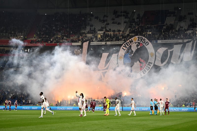 Players arrive on the pitch as Lyon’s supporters display a tifo prior 