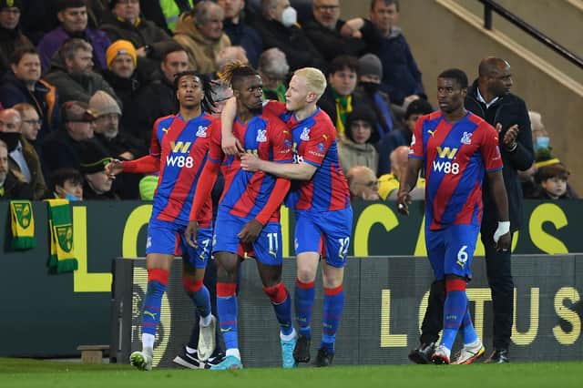 Wilfried Zaha of Crystal Palace celebrates with teammates Michael Olise and Will Hughes (Photo by Harriet Lander/Getty Images)