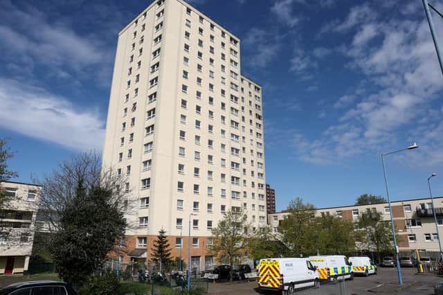 A man has been arrested after a woman died when she fell from a massive tower block. 