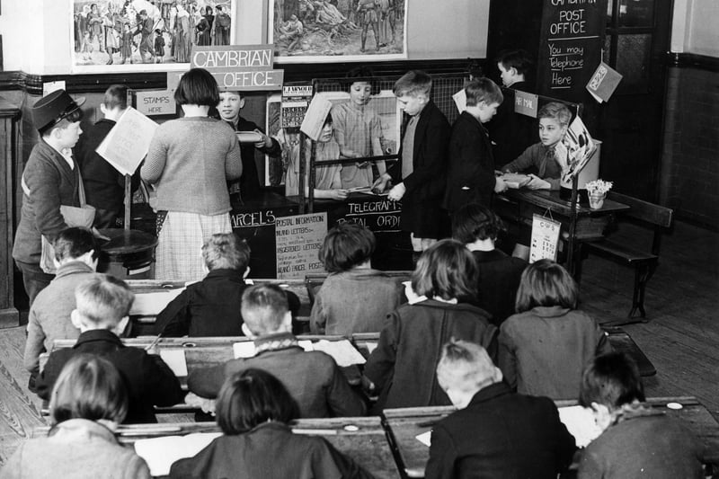 4th March 1936:  Pupils at Cambrian Street School, Beswick, Manchester operating their own post office as an easy way of learning arithmetic and how to run a business. 