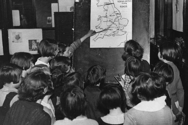18 May 1936:  A group of girls from Manchester study a map showing the Roman roads leading to Bath, where they were soon to embark on a visit