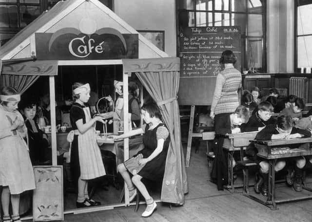 Schoolchildren in Manchester in their home-made cafe, during a maths lesson.  (Photo by Hulton Archive/Getty Images)