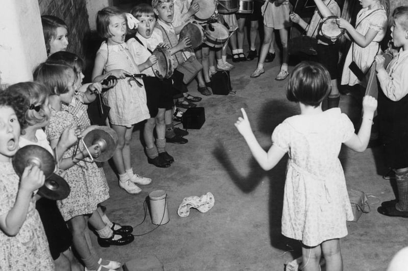 8 August 1940:  Members of the Wilbraham Infants School percussion band practising in a shelter during an air raid in Manchester. The idea is to entertain the children and distract them from the noises outside.  