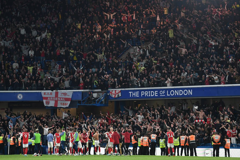 Arsenal players celebrate with their fans after the final whistle