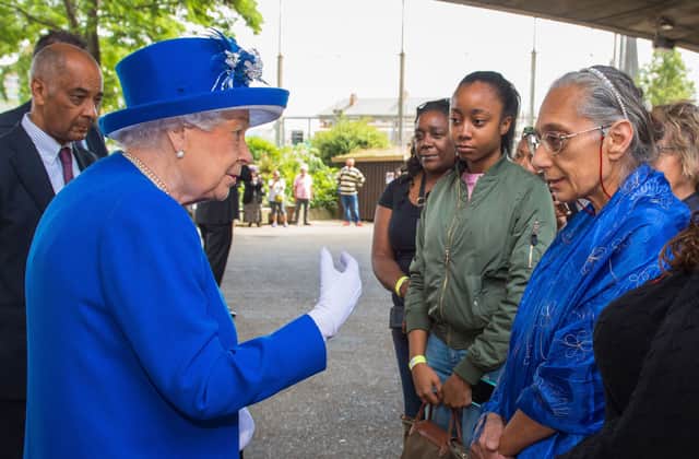 Queen Elizabeth II meets members of the community affected by the fire at Grenfell Tower, during a visit to the Westway Sports Centre which provided temporary shelter for those who were made homeless in the disaster, in west London on June 16, 2017. 