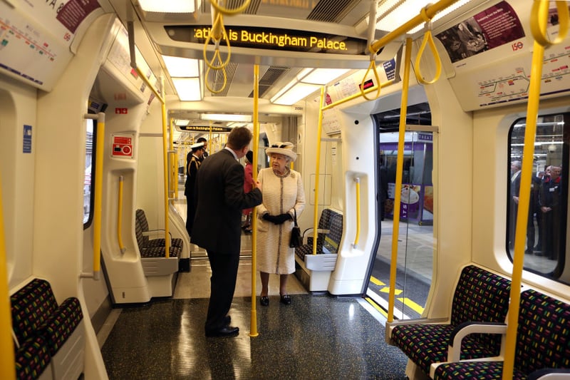 Queen Elizabeth II stands onboard a train as she makes an official visit to Baker Street Underground Station, to mark 150th anniversary of the London Underground on March 20, 2013