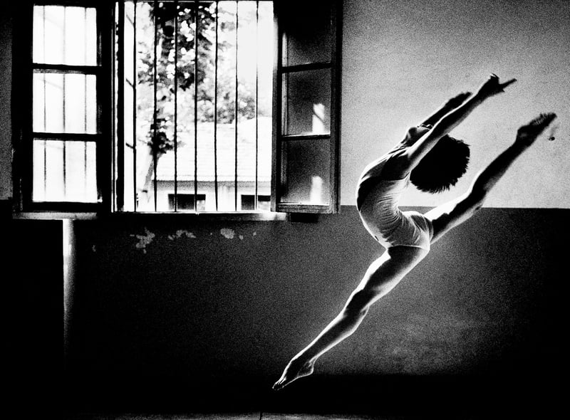 An extraordinary young gymnast practices her leaps at Wuhan School of Sport in a powerful photo taken by Tom Stoddart