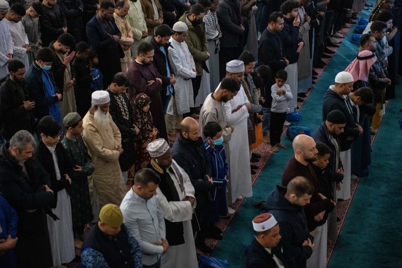 Men take part in morning prayers during Eid Al-Fitr celebrations at East London Mosque in Whitechapel on May 2