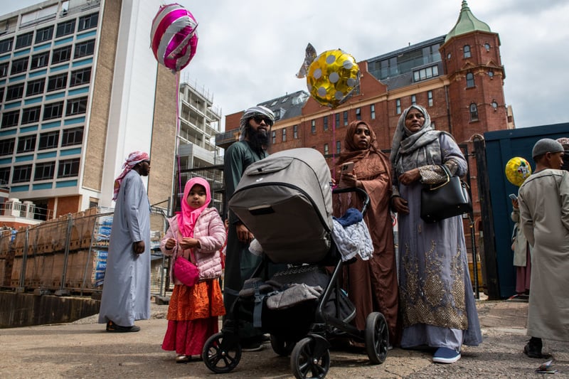A family gathers outside the East London Mosque after morning prayers during Eid Al-Fitr celebrations on May 2