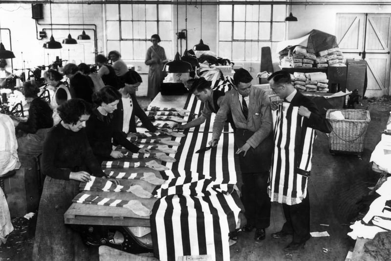 1937: Workers preparing football shirts for Sunderland AFC, and socks for Preston North End FC, at the Bukta factory in Manchester
