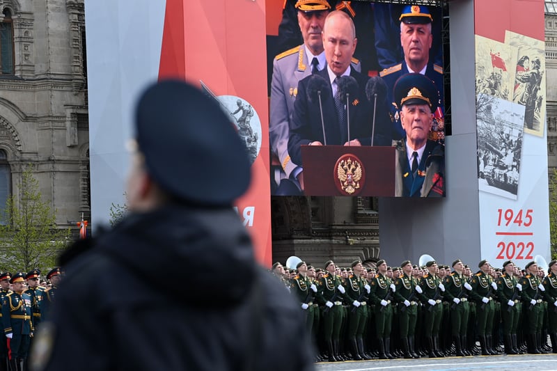 A screen shows Russian President Vladimir Putin giving his speech (AFP via Getty Images)