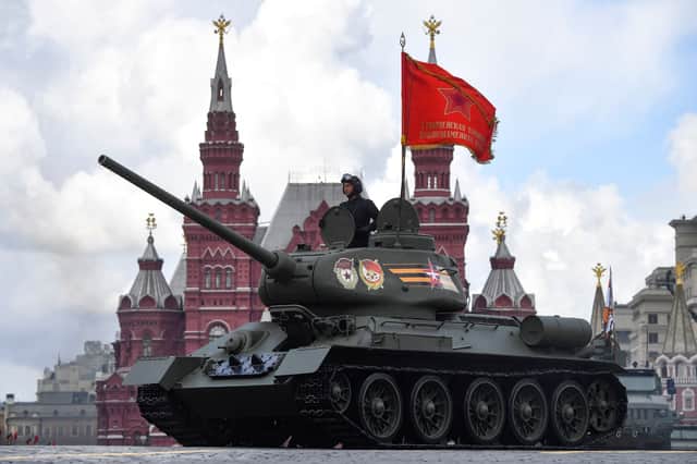 A Soviet era T-34 tank parades through Red Square (AFP via Getty Images)