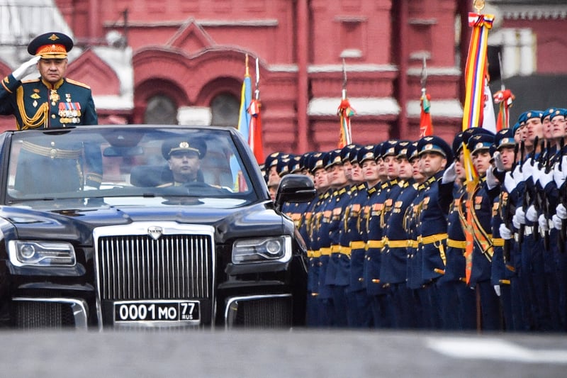 Russian Defence Minister Sergei Shoigu salutes to soldiers as he is driven along Red Square (AFP via Getty Images)