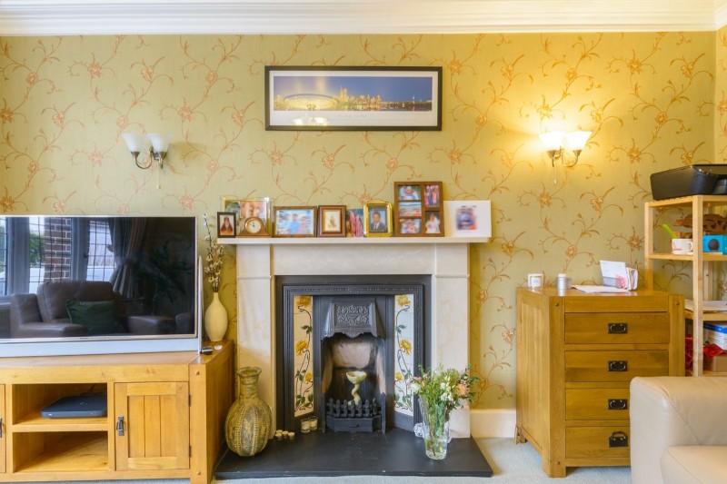 The house has several fantastic traditional features such as wooden panelling and a fireplace within the hallway.