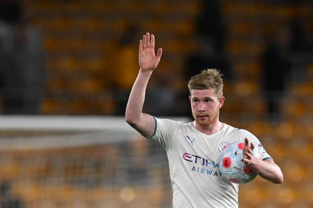 Kevin De Bruyne holds the match ball after scoring four against Wolves . Credit: Getty.