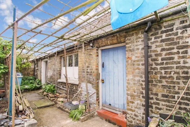 There are also a couple of outhouses that are off the courtyard garden that are used as storage rooms (image: Zoopla)