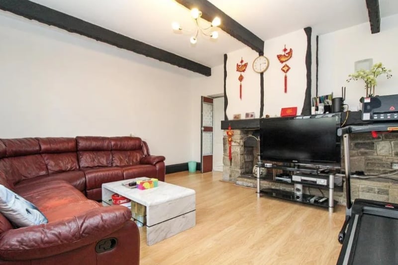 The living room has a spacious, open fire (image: Zoopla)