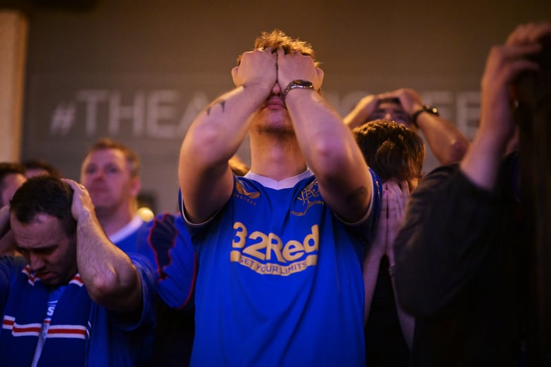 A fan tries to hold back the tears after Rangers lose on penalties.