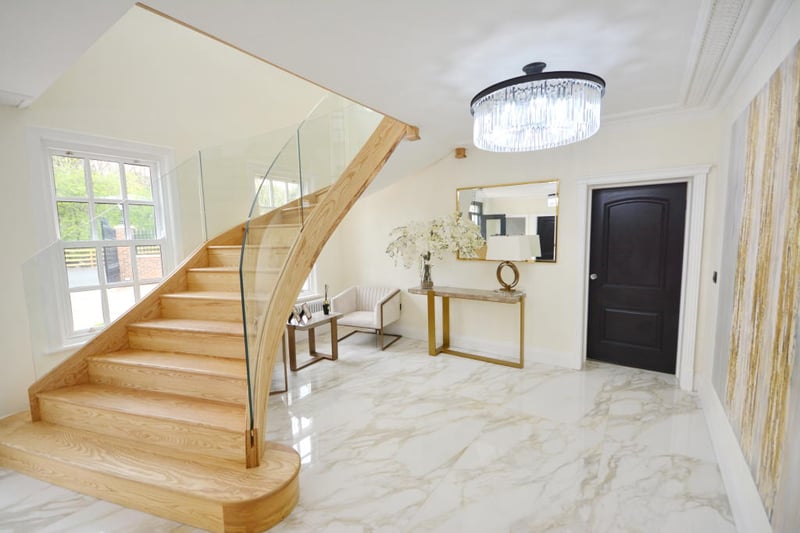 The grand entrance hall features a purpose-built and bespoke sweeping staircase leading you to the first floor.