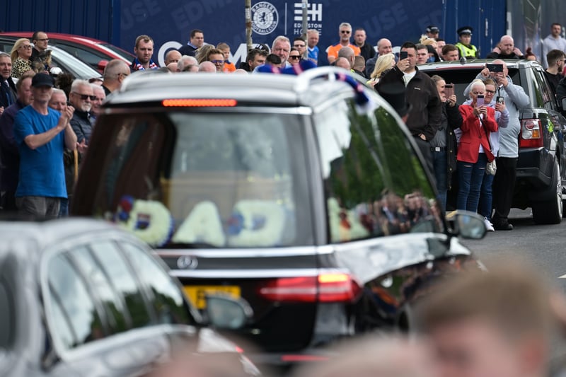 The word ‘DAD’ is displayed in flowers as the hearse carrying Jimmy Bell’s coffin passes the club he devoted over 30 years of his life to