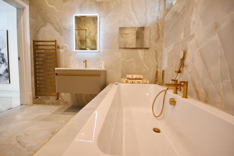 The family bathroom is situated to the left of the landing, there is a significant freestanding bath with gold fittings.