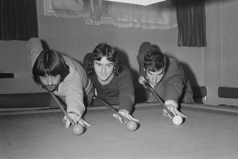 Birmingham City players, from left, Bob Latchford, Trevor Francis and Bob Hatton line up their cues at a snooker table as they plan tactics ahead of a game.