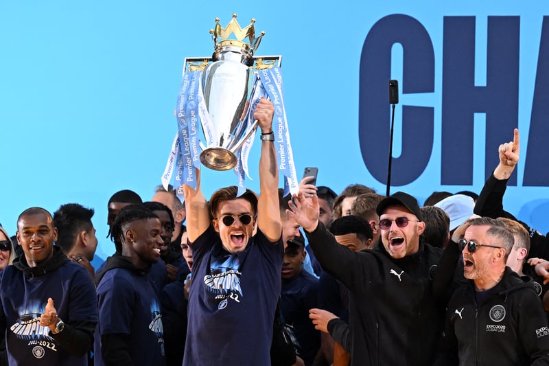 Jack Grealish holds the Premier League trophy on stage