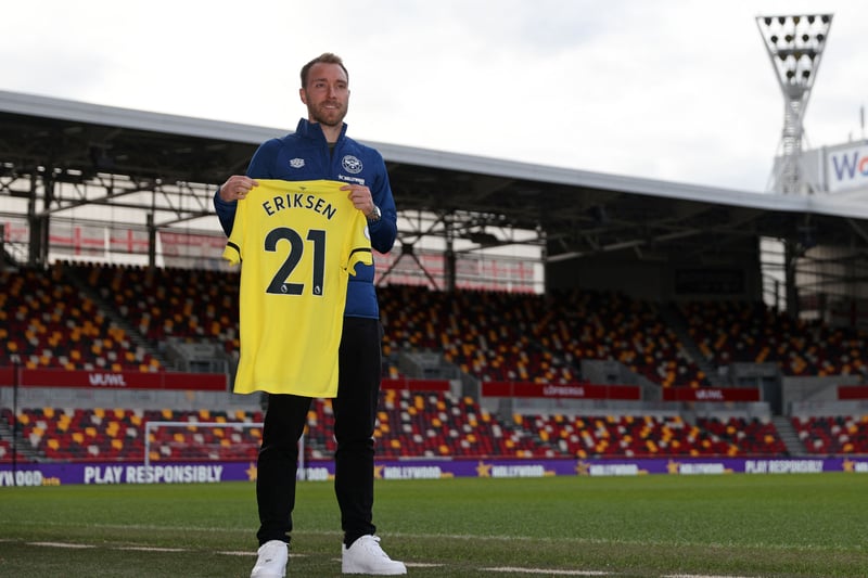 Brentford’s Danish midfielder Christian Eriksen holds a Brentford away shirt as he is introduced to members of the media 