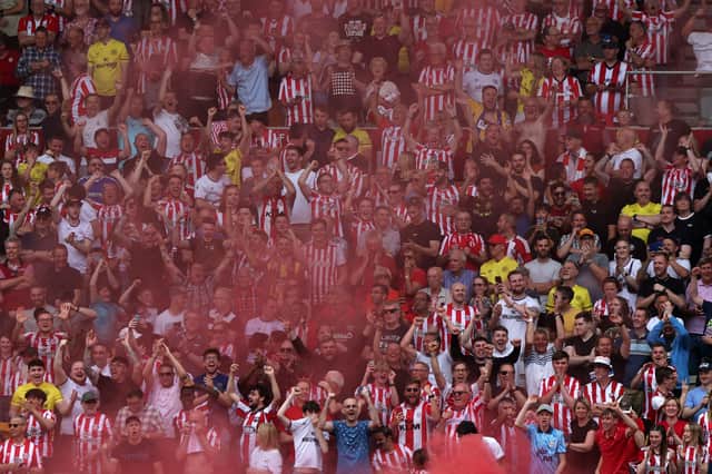 Brentford fans celebrate during the English Premier League football match between Brentford and Leeds United at Brentford Community Stadium 