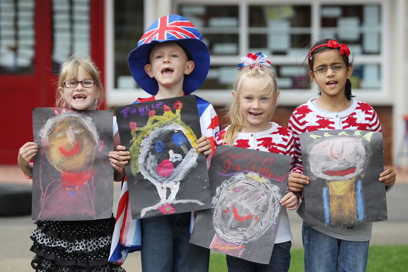 Dogsthorpe Infants School pupils Esme Aldred (6), Taylor Martin (7), Shannon Gallagher (7) and Sana Hussain (7) show off their portraits of the Queen as the school celebrates the Diamond Jubilee. 