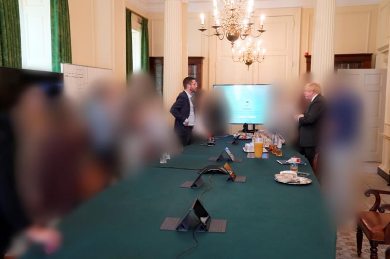 From the same event, as Boris Johnson talks with cabinet secretary Simon Case over a spread of drinks and food