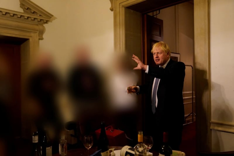 Boris Johnson clutches what appears to be an alcoholic drink while he makes a speech at the leaving do