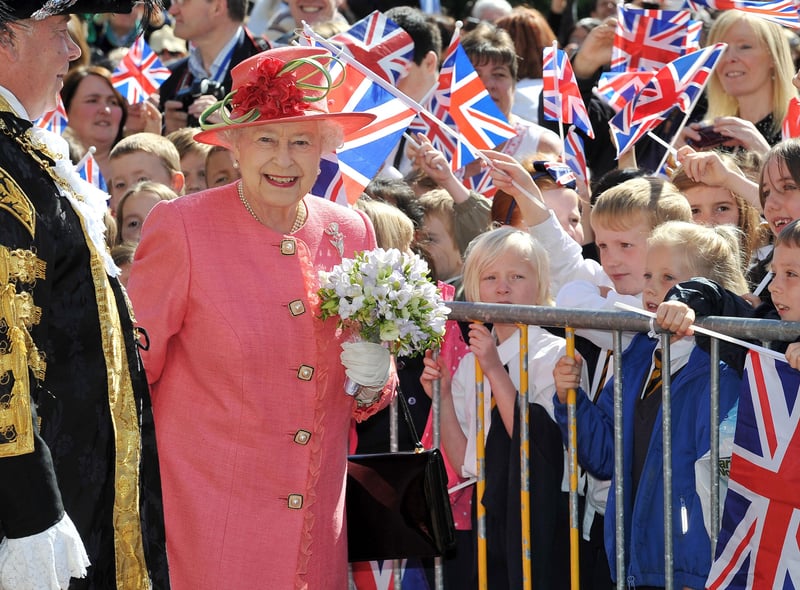 Queen Elizabeth II greets schoolchildren in Victoria Square during her Diamond Jubilee visit to Birmingham on July 12, 2012 (Photo by Tim Ireland - WPA Pool/Getty Images)