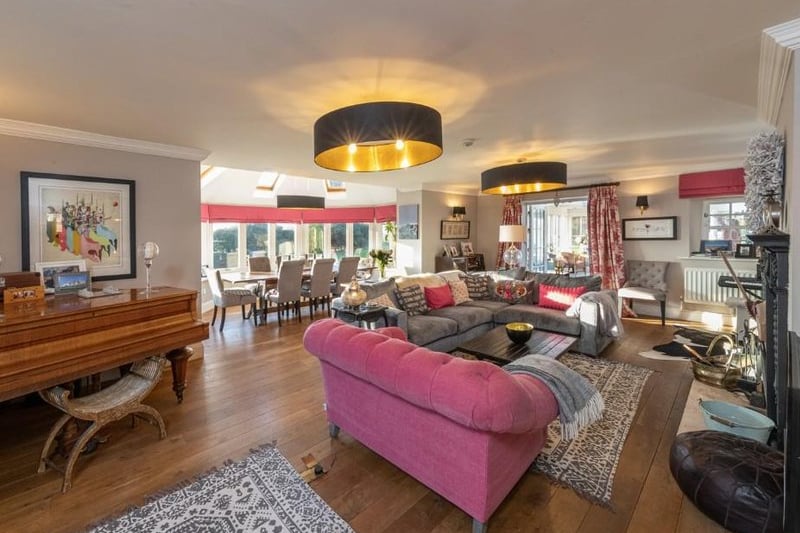 The house has an expansive ground floor which mazes across its land, leading to stunning living spaces like this one. It’s probably a different vibe to Buckingham Palace, but we think the Queen would embrace it. (Image: Rightmove)