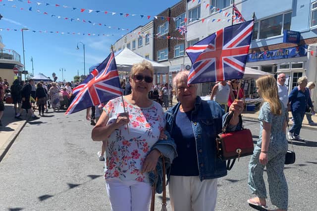 Left to right: Pam Brady and Joan Flowers, both from Gosport, wave their flags during the Lee jubilee celebrations