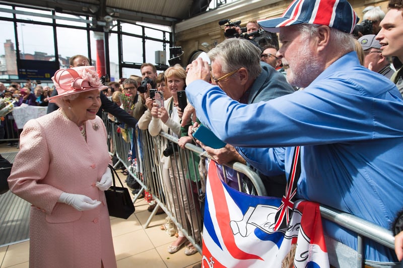 Queen Elizabeth II reacts as she is greeted by wellwishers after arriving by Royal Train at Liverpool Lime Street Station in Liverpool.