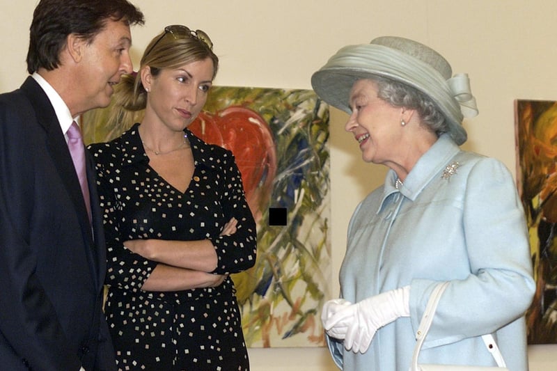 Sir Paul McCartney with his then wife Heather Mills, shows Queen Elizabeth II his paintings at the Walker Art Gallery in Liverpool where he has an exhibition on display. Earlier the Queen had opened Liverpool’s John Lennon Airport as she continued her Jubilee tour of the North West and later she was due to open the Commonwealth Games in Manchester.