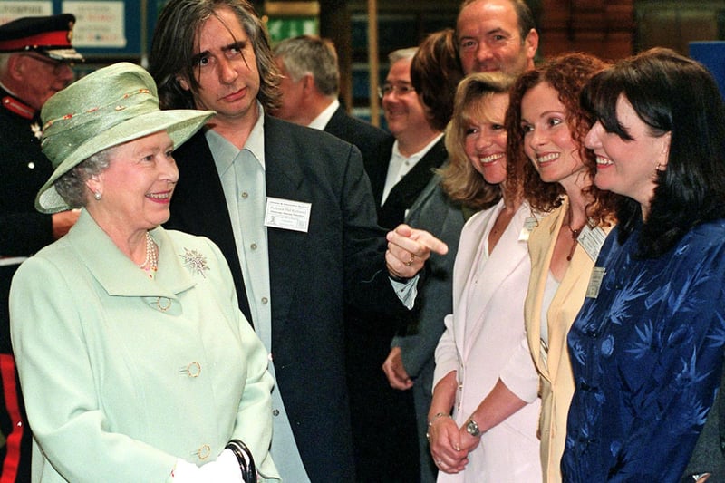 Queen Elizabeth, stops to chat to members of the cast from the TV soap ‘Brookside’ at Liverpool Central Library during her visit to the city in 1999.