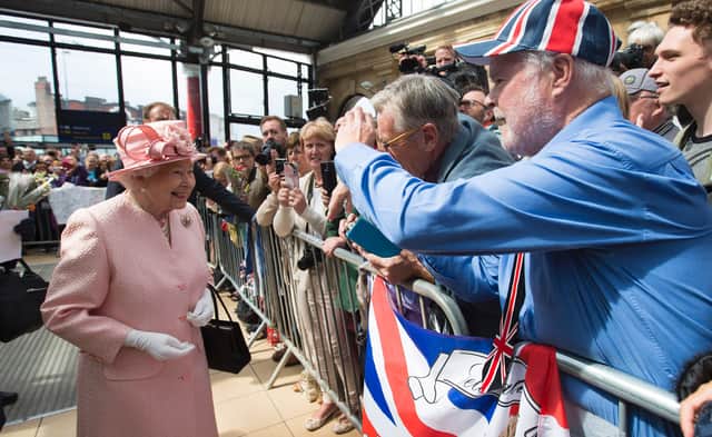 Queen Elizabeth II is greeted by wellwishers after arriving by Royal Train at Liverpool Lime Street Station.