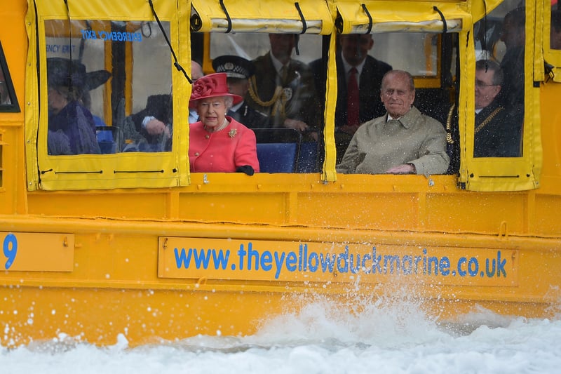 Queen Elizabeth II and Prince Philip, Duke of Edinburgh take a ride on the Yellow Duckmarine during a visit to Merseyside Maritime Museum.