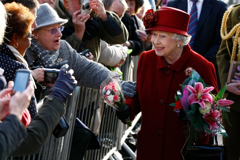 Queen Elizabeth II greets members of the public after paying a visit to the Museum of Liverpool.