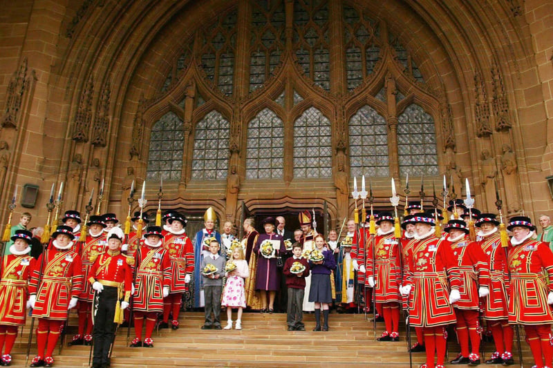 Queen Elizabeth II (C) poses with the Yeoman of the Guard after the Royal Maundy Service held at Liverpool’s Anglican Cathedral.  Traditional Maundy gift purses containing minted coins were handed to 78 men and 78 women, the number selected to mark the Queen’s 78th year.