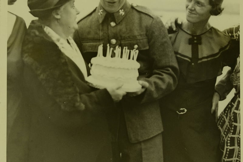 800 relatives of the men of the 1st Battalion the Manchester Regiment made a railway journey in two special trains from the Manchester area to Southampton and back, to enjoy the briefest of reunions; here a man receives a 21st birthday cake